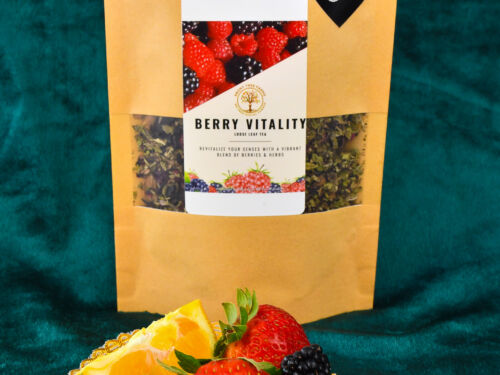 A picture of the two ounce loose leaf tea. There is a small plate of fruit on display in front of the package
