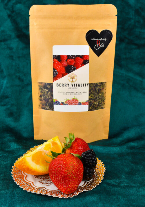 A picture of the two ounce loose leaf tea. There is a small plate of fruit on display in front of the package