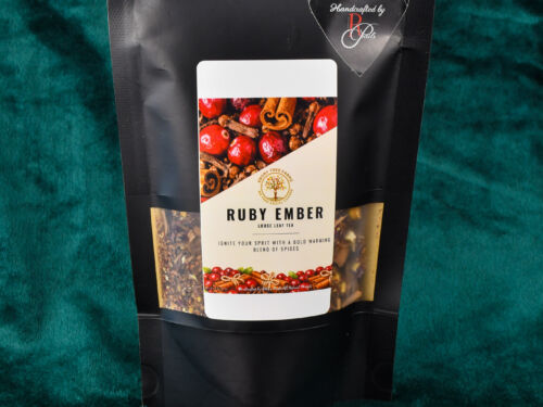 A picture of the custom blend two ounce loose leaf tea. There is a small plate in front of the product with cloves and cinnamon on display